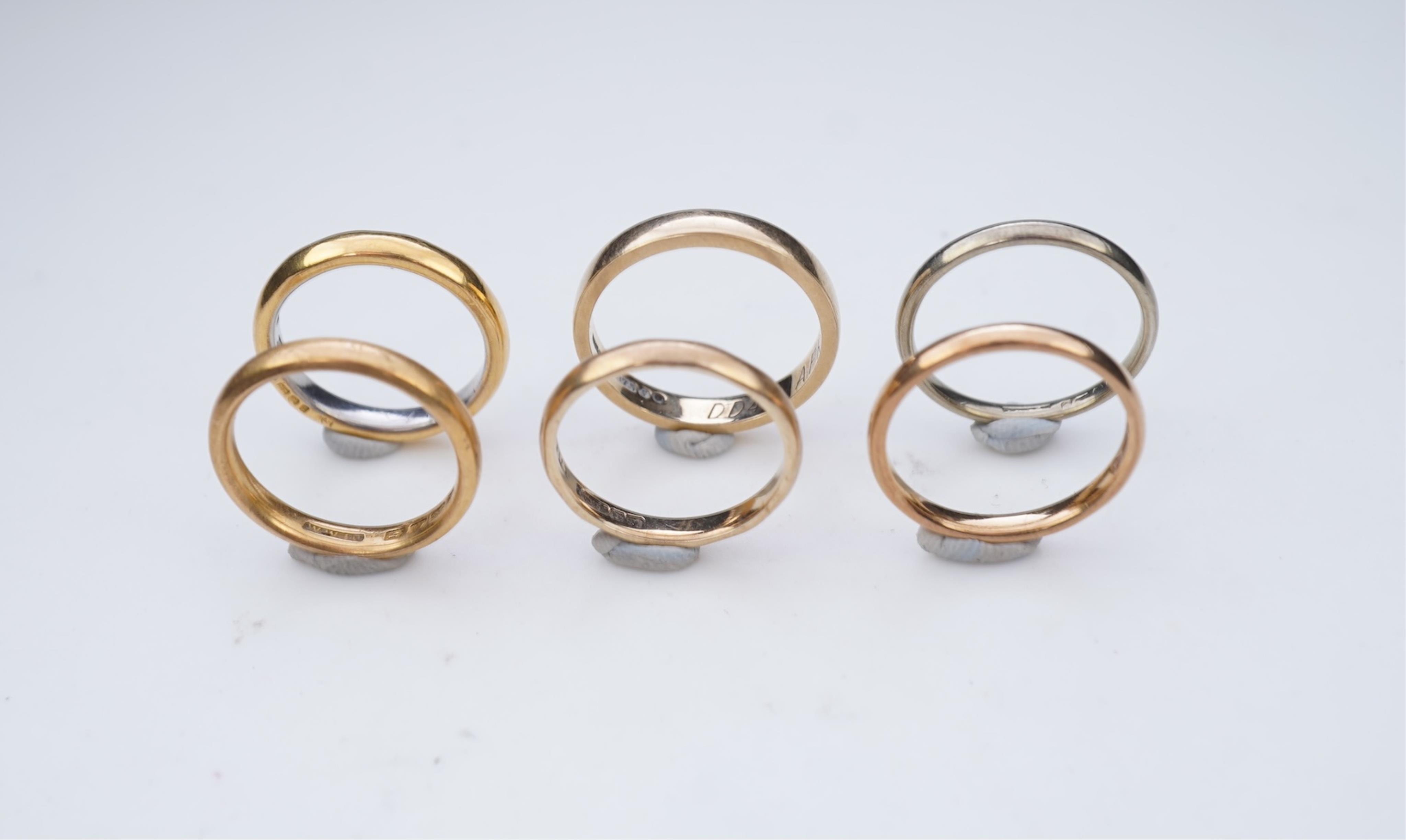 A collection of six gold wedding bands